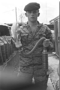 Lt. Tolley showing captured Russian gas mask, then riding Jeep in front of Tay Ninh Temple.