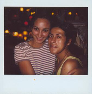 A Polaroid of Melissa Posing with a Person in a Striped Shirt