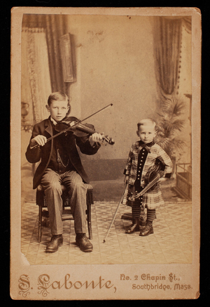 Portrait of two young boys with violins