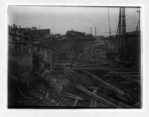 View of construction site, showing wood and steal beams and machinery