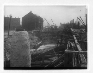 View of railroad tracks showing wood beams and buildings