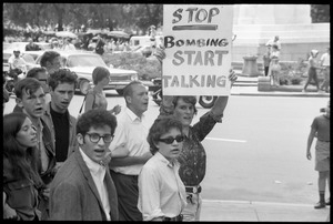 Assembly of Unrepresented People protesters during anti-war march, one carrying a sign reading 'Stop bombing, start talking'