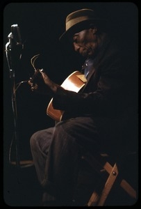 Mississippi John Hurt: in concert, playing guitar