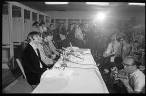 Ringo Starr, Paul McCartney, John Lennon, and George Harrison (l. to r.) seated at a table during a Beatles press conference