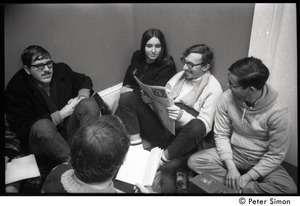 Protesters reading the news during the occupation of the University Placement Office, Boston University, opposing on-campus recruiting by Dow Chemical Co.