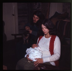 Nina Keller with infant, Tony Mathews in rear, and cat, Montague