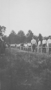 Students lining up for a Rope Pull near the campus pond
