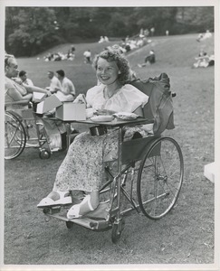 Woman in wheelchair eating lunch