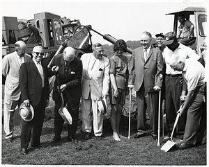 Mayor John F. Collins, unidentified woman, and unidentified men posing with shovels at groundbreaking ceremony