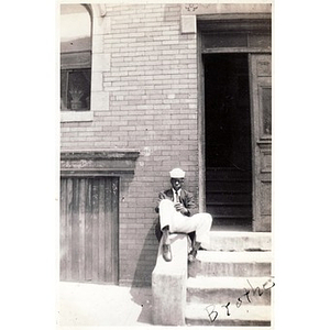 "Brother" Irish sits on the steps to his home on Haskins Street