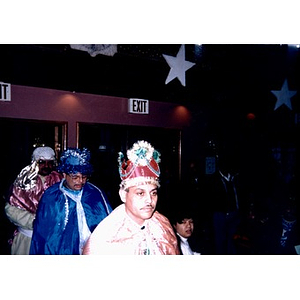 Three men dressed as the Three Kings enter the Jorge Hernandez Cultural Center.