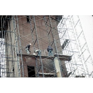 Workmen on the scaffolding that surrounds the tower of the former Shawmut Congregational Church.