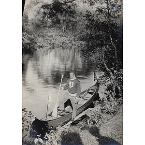 Charles H. Bruce, standing in canoe