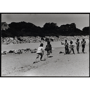 Children play a game on a beach