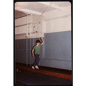 A boy walks on a balance beam at the Charlestown gymnasium