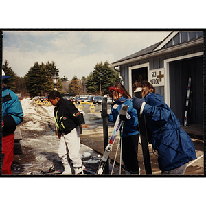 Two children put on skis at a resort