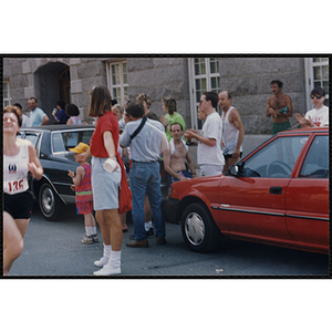 Spectators cheer a woman running in the Bunker Hill Road Race