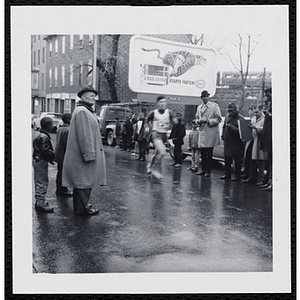 A runner passes spectators during the Roxbury Road Race