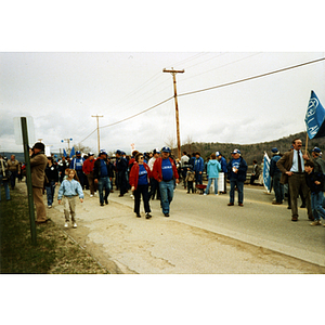 Union members and their families march in the International Paper Company workers' strike