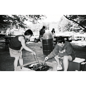 Young adults cook food at a Chinese Progressive Association picnic