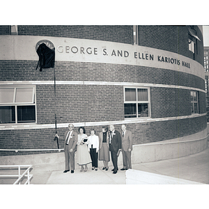 George and Ellen Kariotis reveal the Kariotis Hall plaque while President Kenneth Ryder and others look on