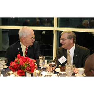 Eugene Reppucci and another man converse at the Veterans Memorial dinner