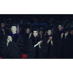 Students standing and clapping at the School of Law Commencement ceremony