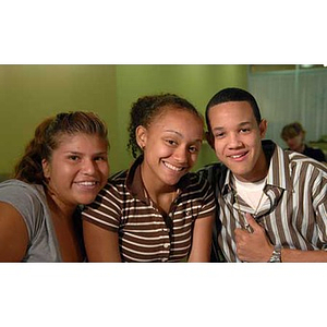 Three students smile during the Torch Scholars visit to the Exhibition Kitchen