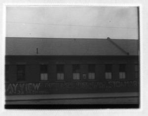 View of building with advertising graffiti, probably on Dorchester Ave.