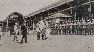 View in front of the canteen of two Red Cross workers receiving the Croix-de-Guerre with soldiers standing at attention, Châlons