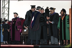 Ahmad Kathrada (2nd from right), on stage after receiving honor doctor of laws degree, UMass Amherst