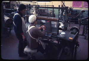 Cotton Mill No. 2: Two women at machine, setting pattern for loom