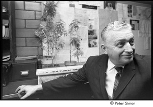 Cambridge Narcotics Unit: officer seated with confiscated marijuana plants in the background