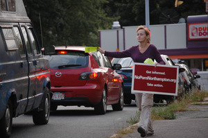 Protest against a pornographic video store in Northampton: protester with sign 'NoPornNorthampton.org,' handing out fliers to cars on North Street