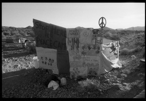 Signs posted at the Nevada Test Site peace encampment" 'Stop here for peace camp'