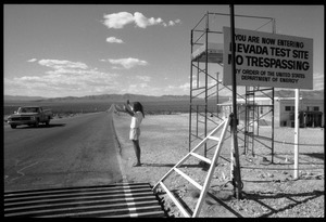 Peace encampment activist waving at automobile leaving the Nevada Test Site