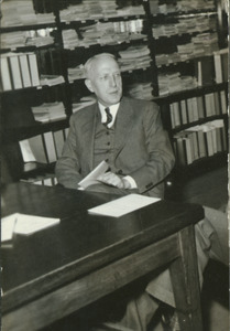 Charles P. Alexander sitting at a study table