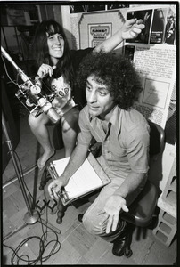 Abbie Hoffman: unidentified woman and Hoffman (right) at the microphone, WBCN studio