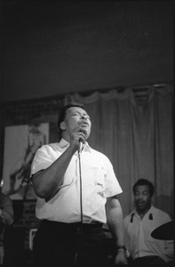 James Cotton at Club 47: James Cotton singing into a microphone with Francis Clay playing drums at right