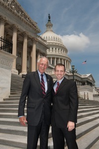 Congressman John W. Olver (center) with unidentified man, posed on the steps of the United States Capitol building