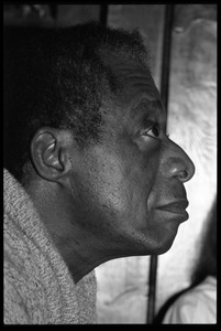 James Baldwin: informal portrait in profile, close-up, at the book party for Robert H. Abel