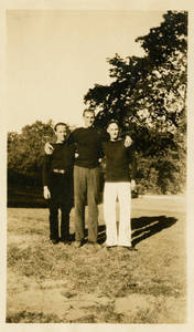 Leon M. Smith standing with two men
