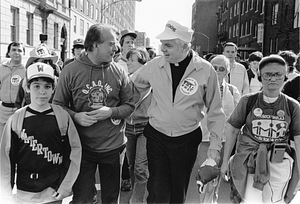 Archbishop Bernard F. Law participating in a Walk for Hunger by Project Bread with unidentified people