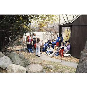 Group of children listening to an adult speaking on a nature walk