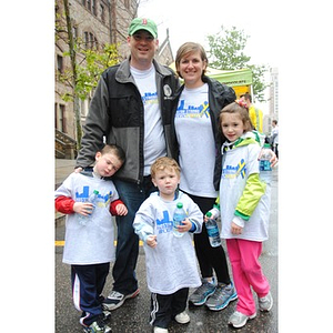 A family of five in Boston Strong #OneRun t-shirts pose for a photo