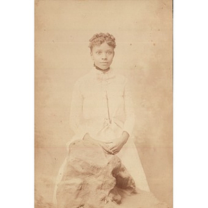 A young African American woman in a white dress