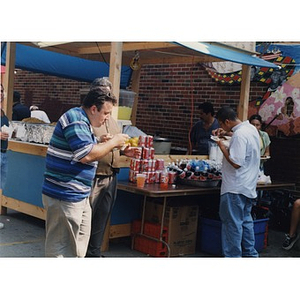 People eating near a concession stand at Festival Betances.