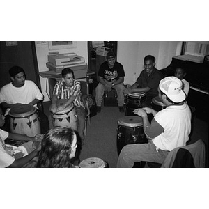 Areyto instructor teaching students how to play conga drums.