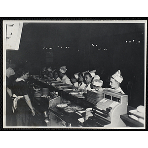 Members of the Tom Pappas Chefs' Club stand on line in a cafeteria