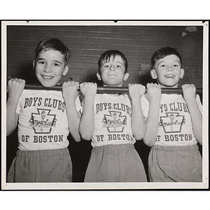 Three boys compete in a pull-up contest during National Boys Club Week at the Roxbury gymnasium